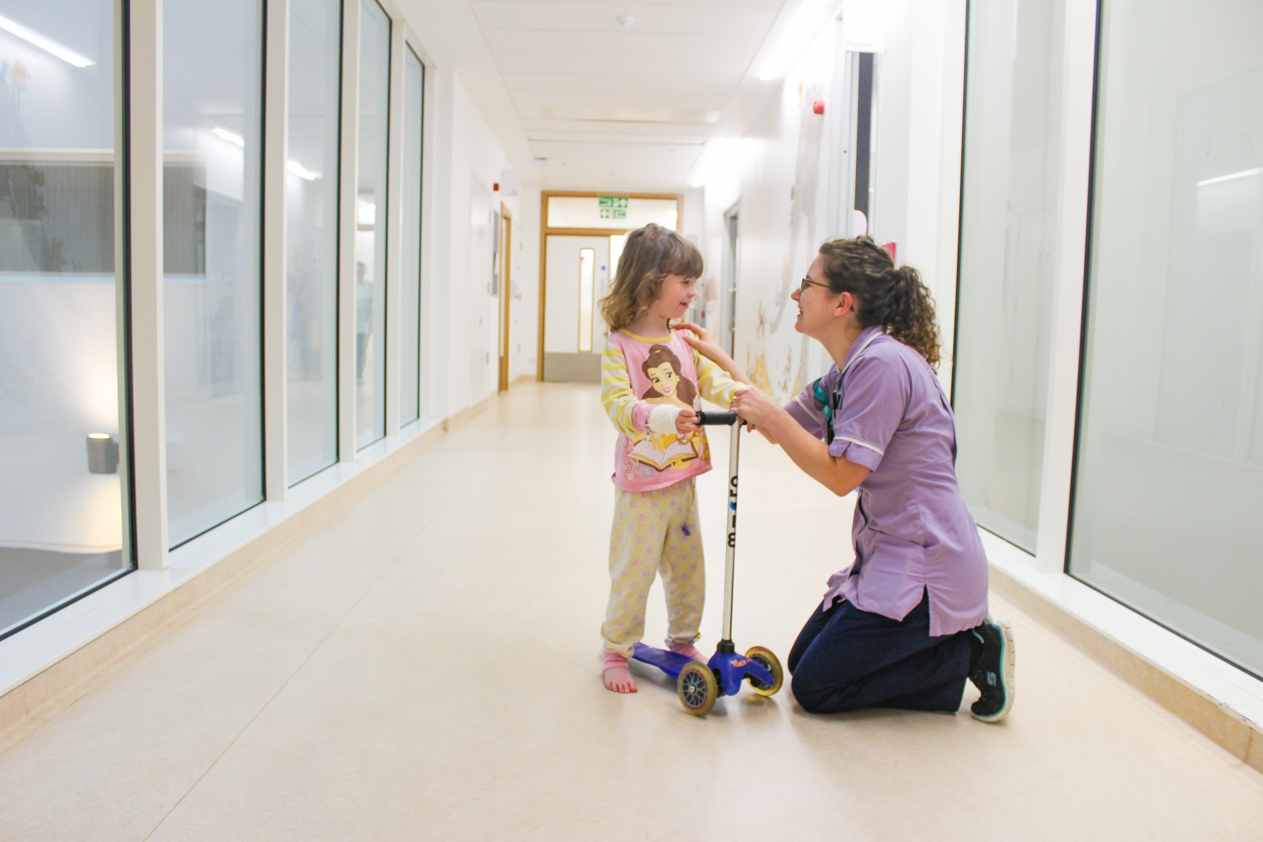 Nurse speaking to young child patient