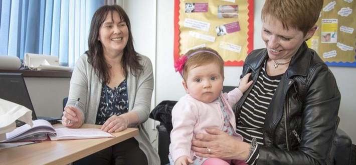 health visitor with mum and baby