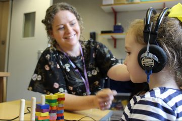 Audiologist checks a childs hearing