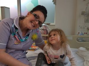 Young blonde girl and her nurse in hospital 