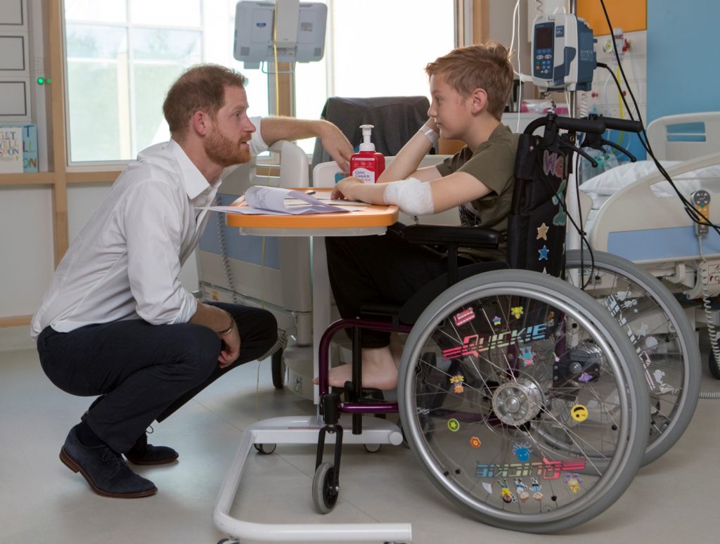 Prince Harry talks to young patient Heath