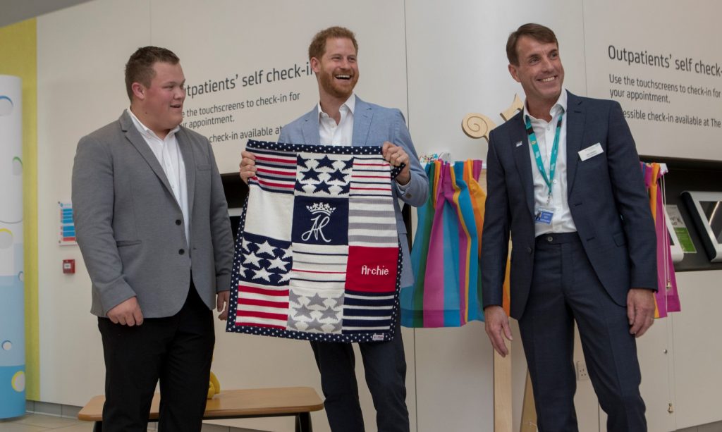 Prince Harry shows off a blanket for his son Archie, gifted to him by George Marriott, head of the Sheffield Childrens Youth Forum