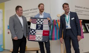 Prince Harry shows off a blanket for his son Archie, gifted to him by George Marriott, head of the Sheffield Childrens Youth Forum
