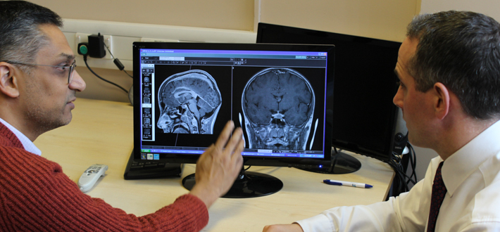 Two doctors discuss a brain scan