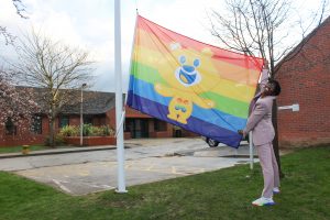 Dr Ronx raising the Rainbow Flag