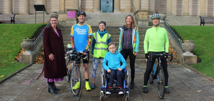 five people stood outside Weston Park with bikes