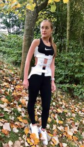Olivia, 16, in a back brace in a woodland area