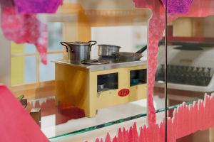 mini brown wooden cooker with metal pots