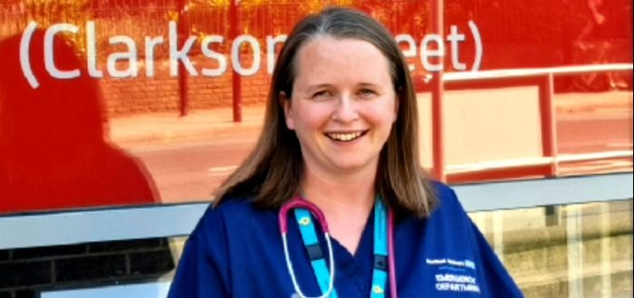 dr rachel outside hospital in blue scrubs